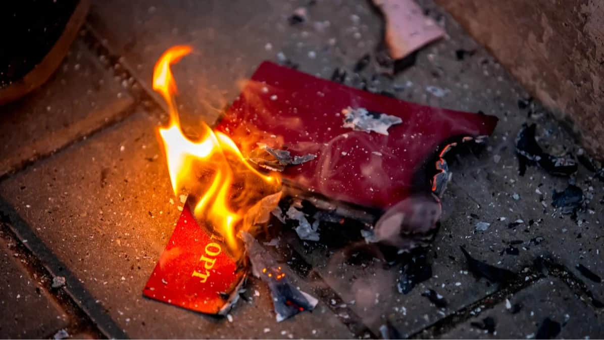 A Russian passport is set ablaze at a protest outside the Russian Embassy in Chisinau, Moldova, 16 February 2024. Photo: Dumitru Doru / EPA